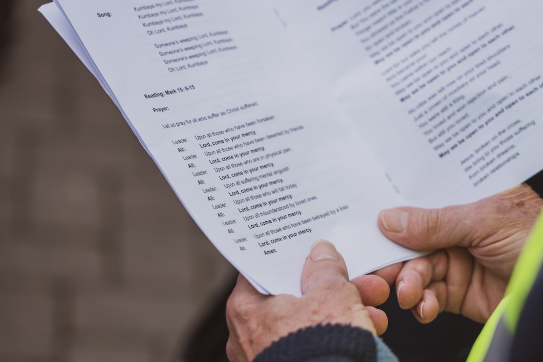 a close up of a person holding a piece of paper